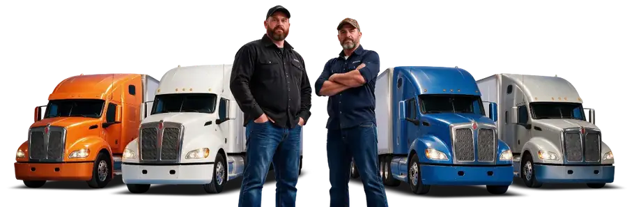 Two trucking instructors standing among four semi trucks